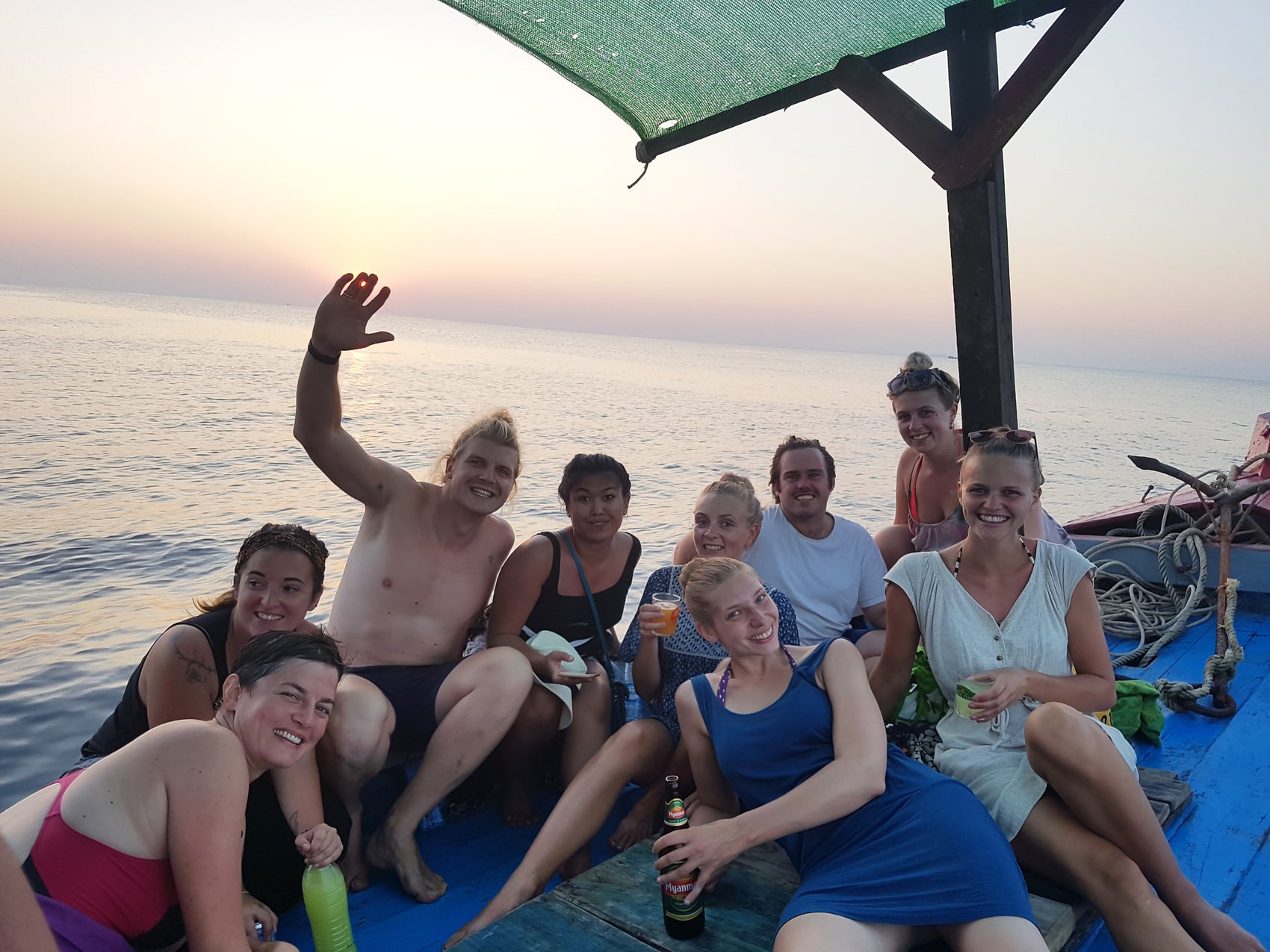 Bryn and Nick having fun with guests on a boat in Myanmar
