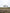 Four friends doing star jumps in front of a white hilltop monument on a treasure hunt