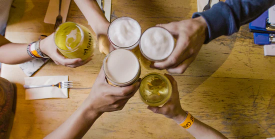 Group celebrating the end of a treasure hunt together in a pub