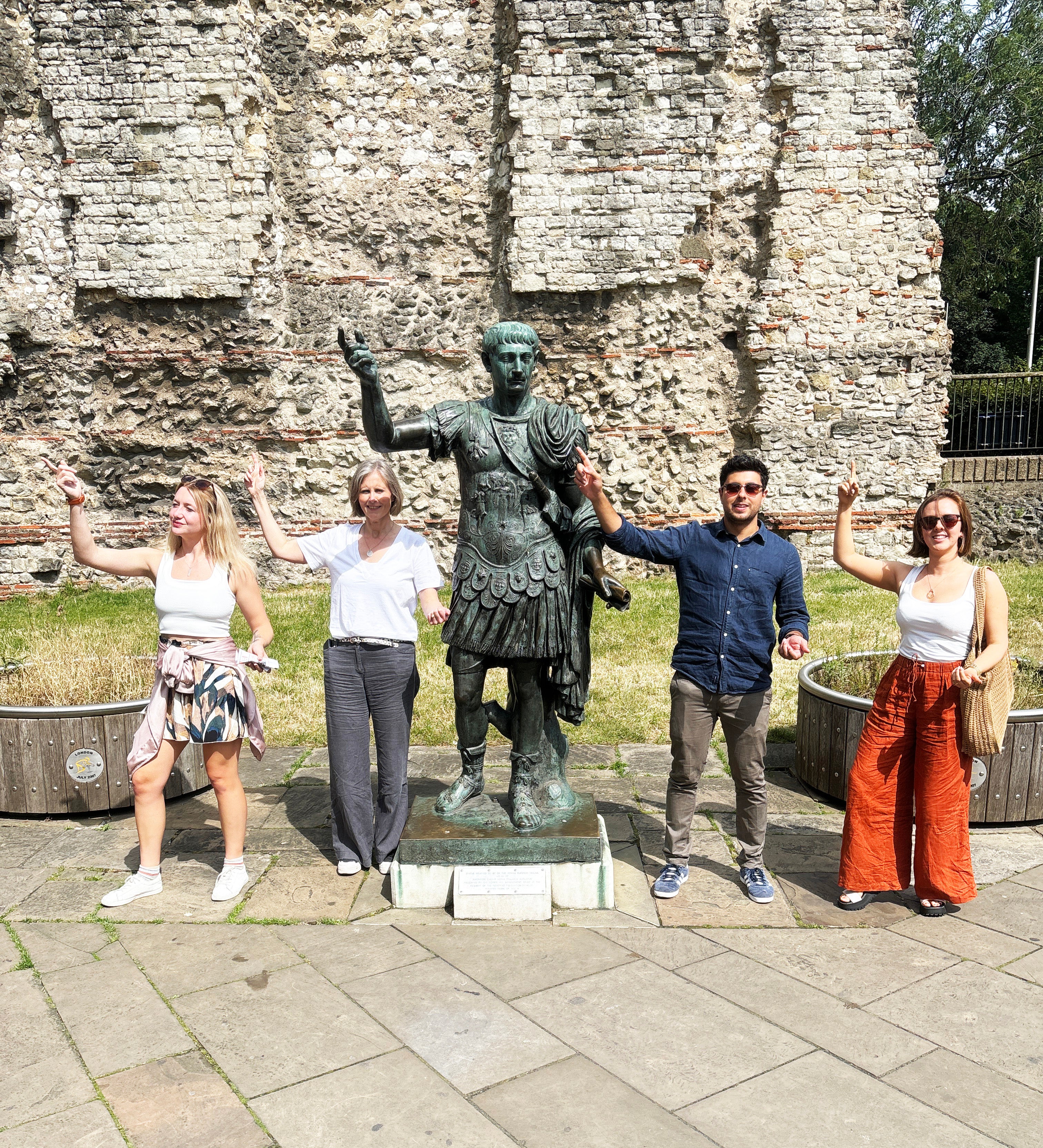 Colleagues completing interactive photo challenges during a corporate team building treasure hunt