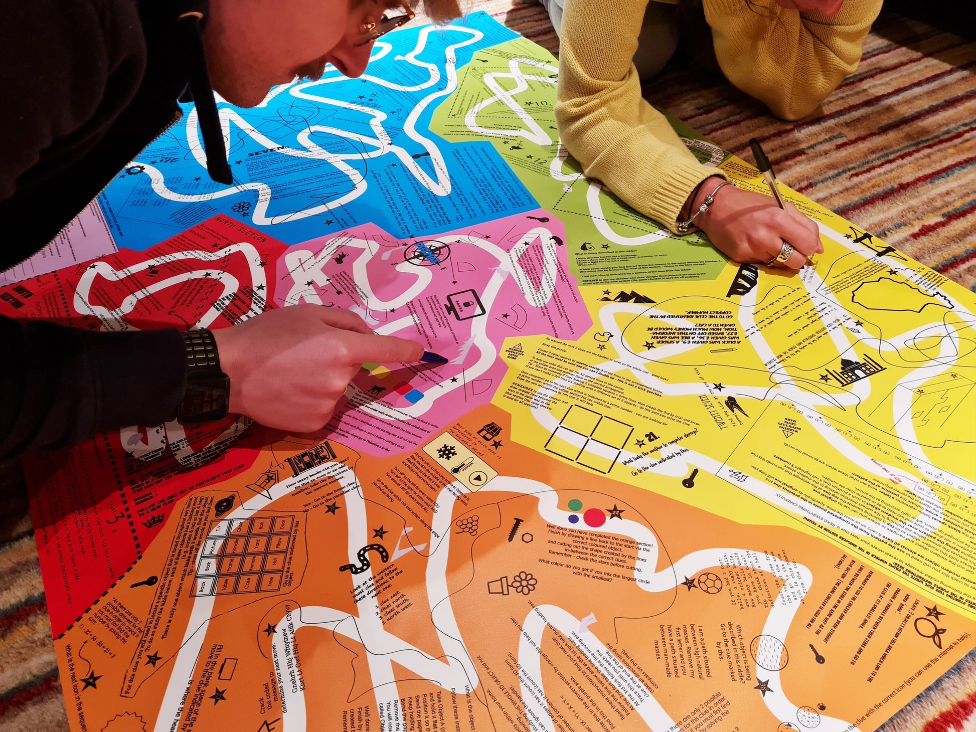 Two friends playing Puzmat puzzle game indoors