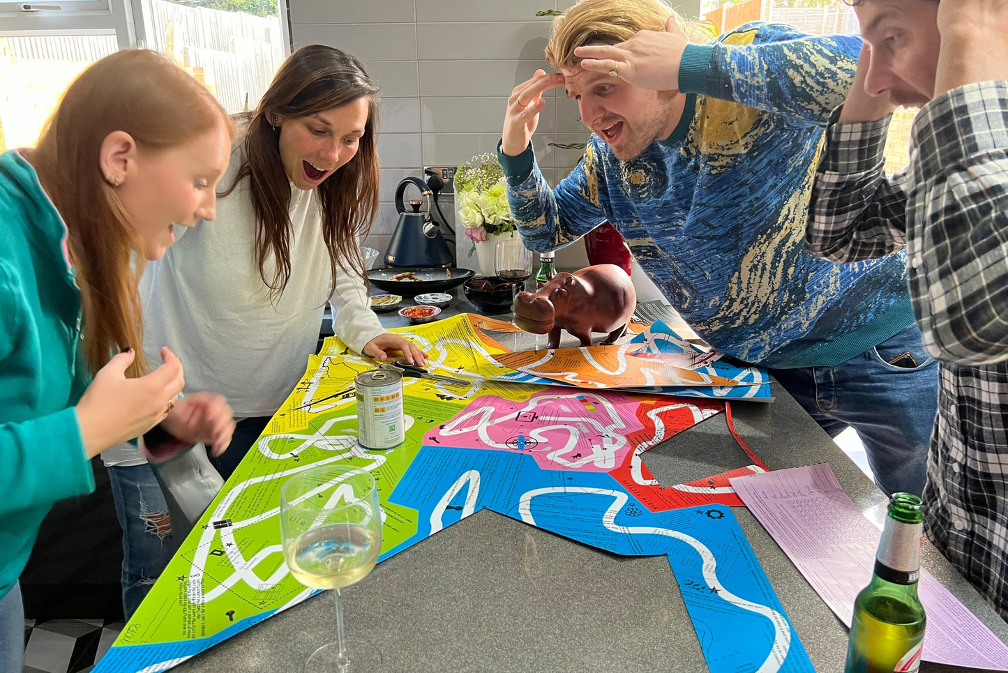 Players focused on the Puzmat puzzle board